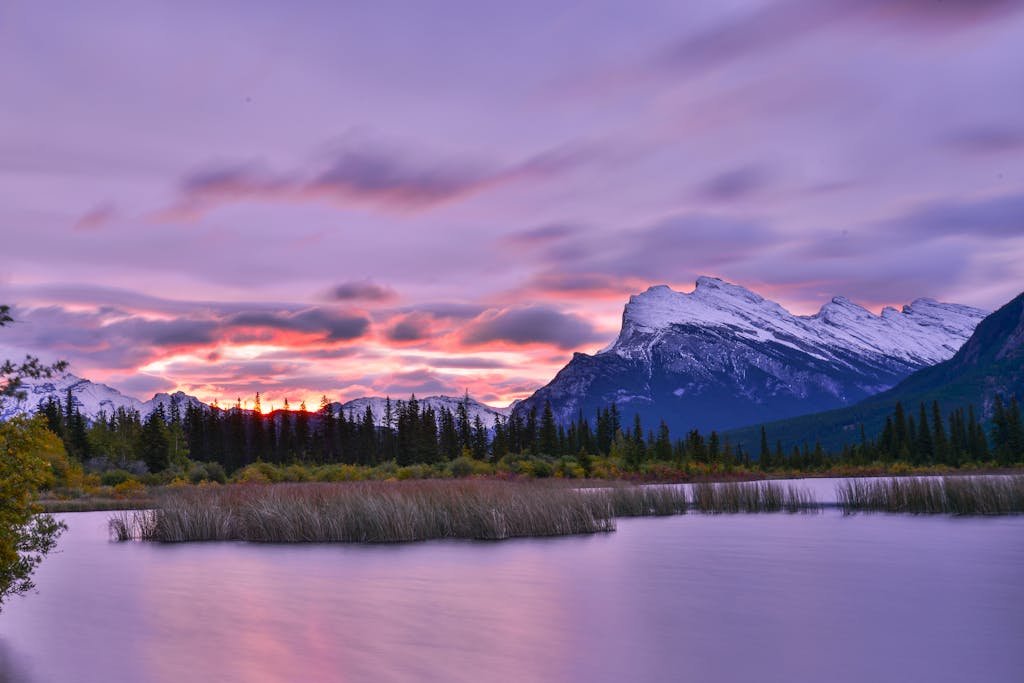 A tranquil sunrise over Vermilion Lakes with stunning snow-capped mountains in Banff, Canada.